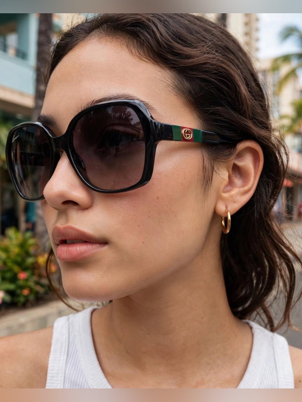 Gucci sunglasses with GG logo and red and green stripes.